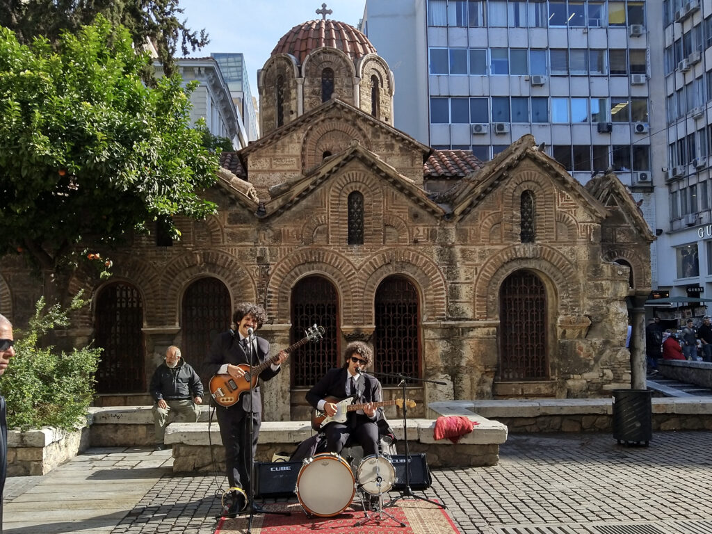 A Beatles cover band performing in front of the Panagia Kapnikarea Church in the centre of Athens, photo by Sophie Huijts