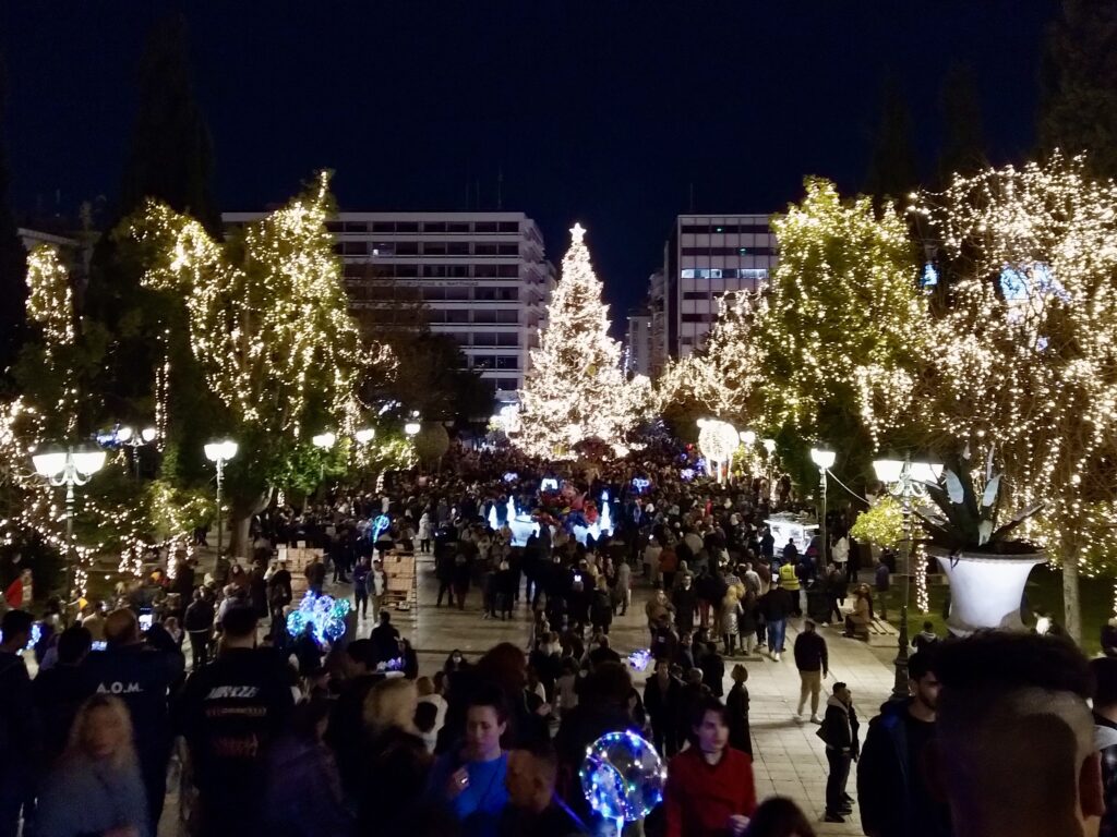 Syntagma Square in central Athens with Christmas tree and covered in Christmas lights, busy with people. Photo by Sophie Huijts