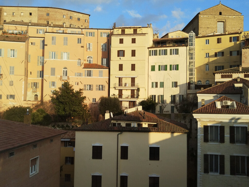 Window view of houses uphill in the centre of Ancona, photo by Sophie Huijts
