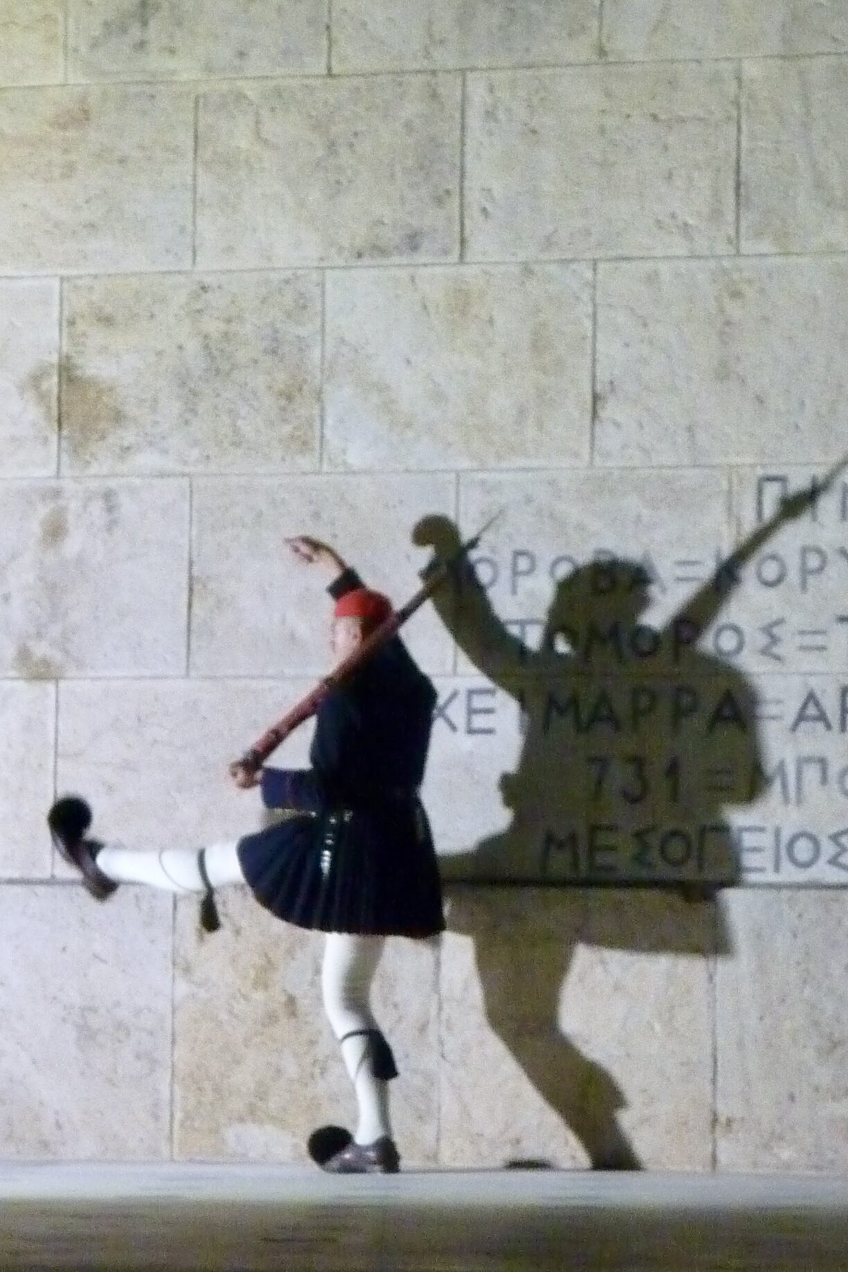 Evzonas in traditional costume marching in front of the Tomb of the Unknown Soldier underneath the Voulí parliament building at Syntagma Square in Athens, photo by Sophie Huijts